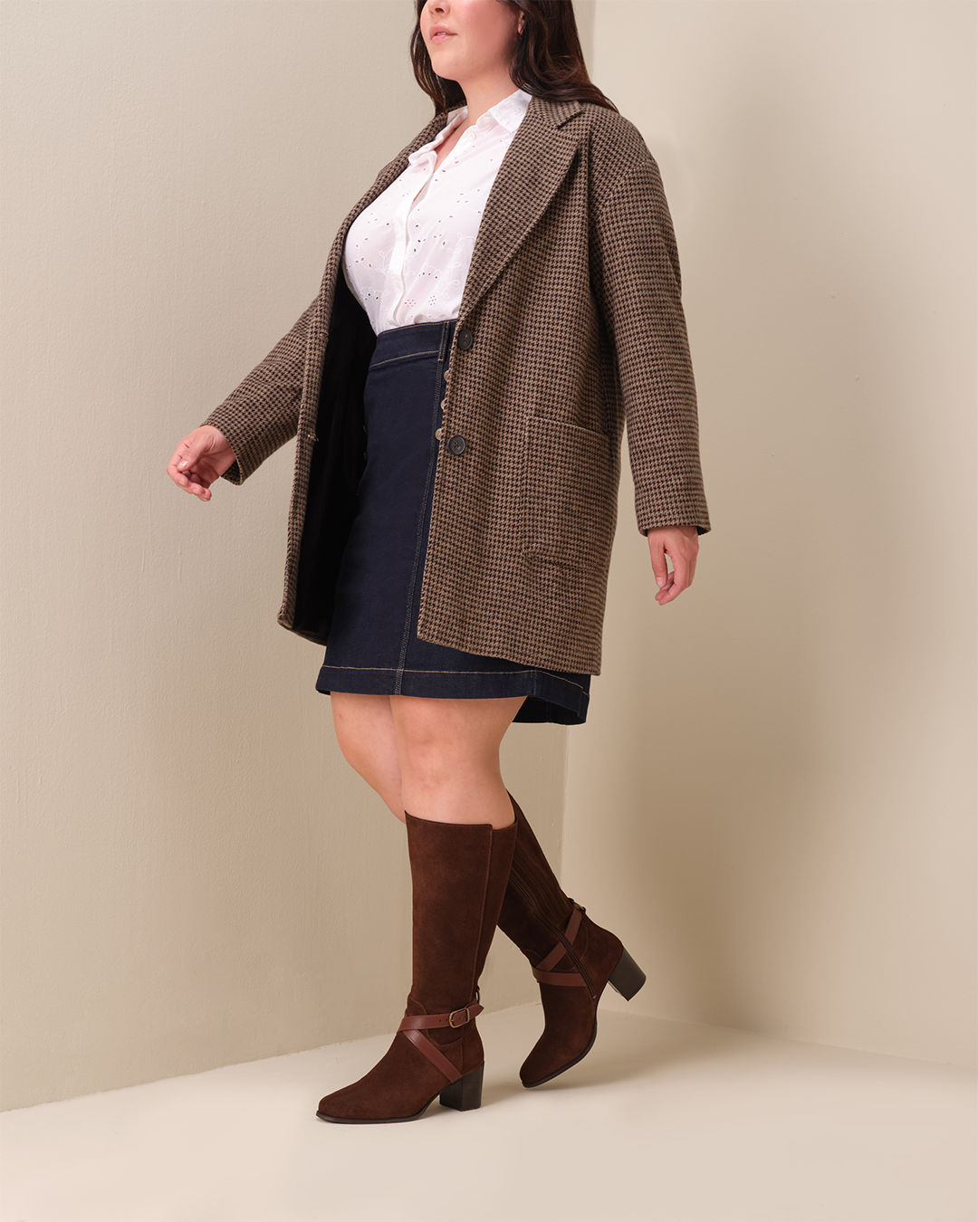 woman wearing knee high brown suede heeled boots with buckle