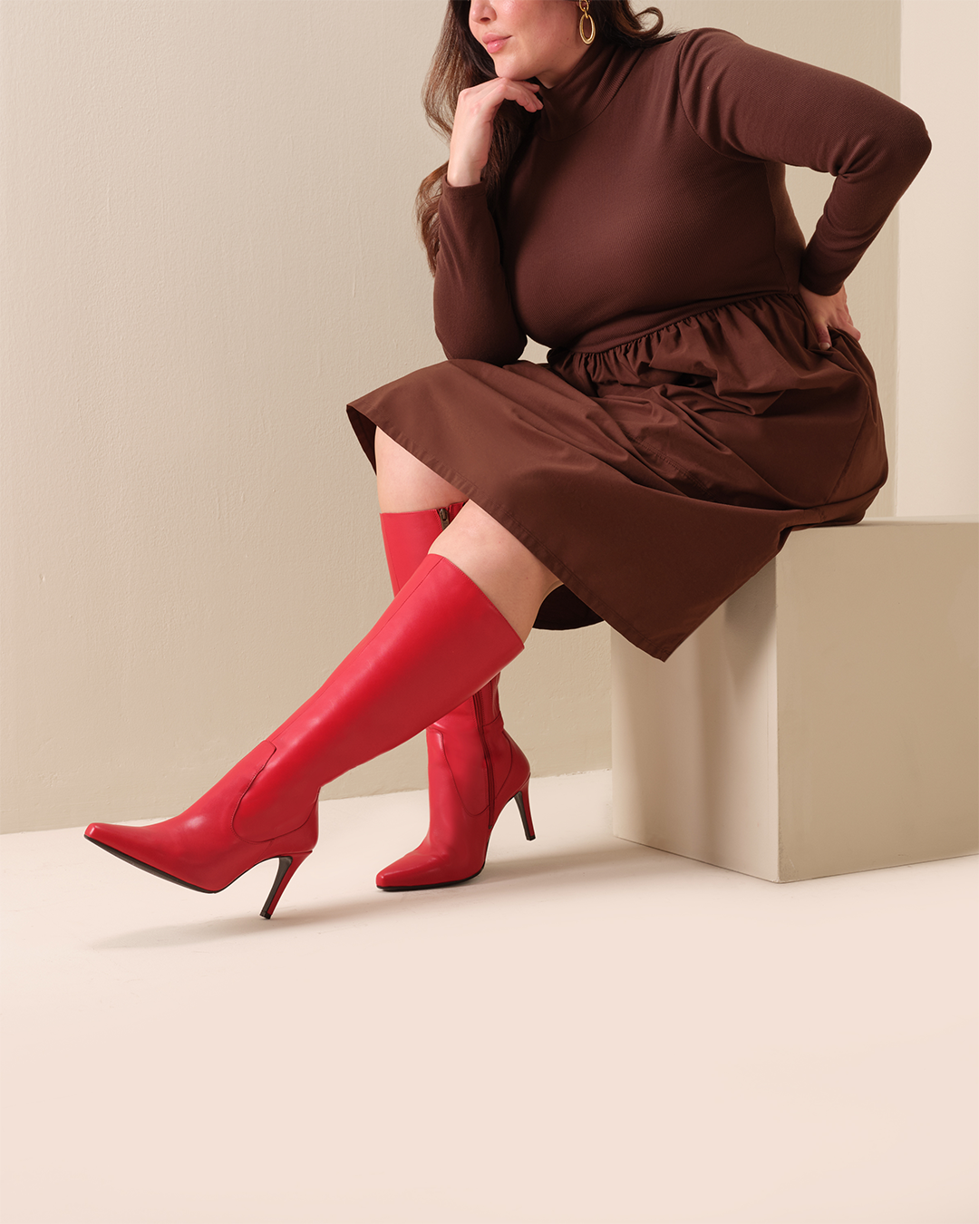 woman wearing knee high red leather stiletto boots