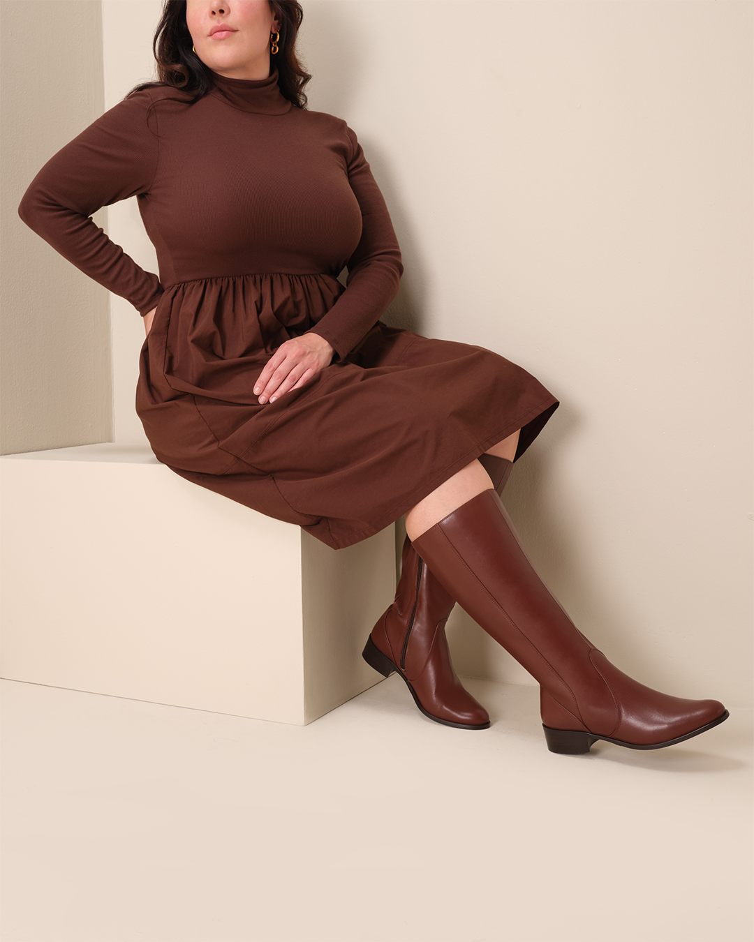 woman wearing knee high brown leather flat boots