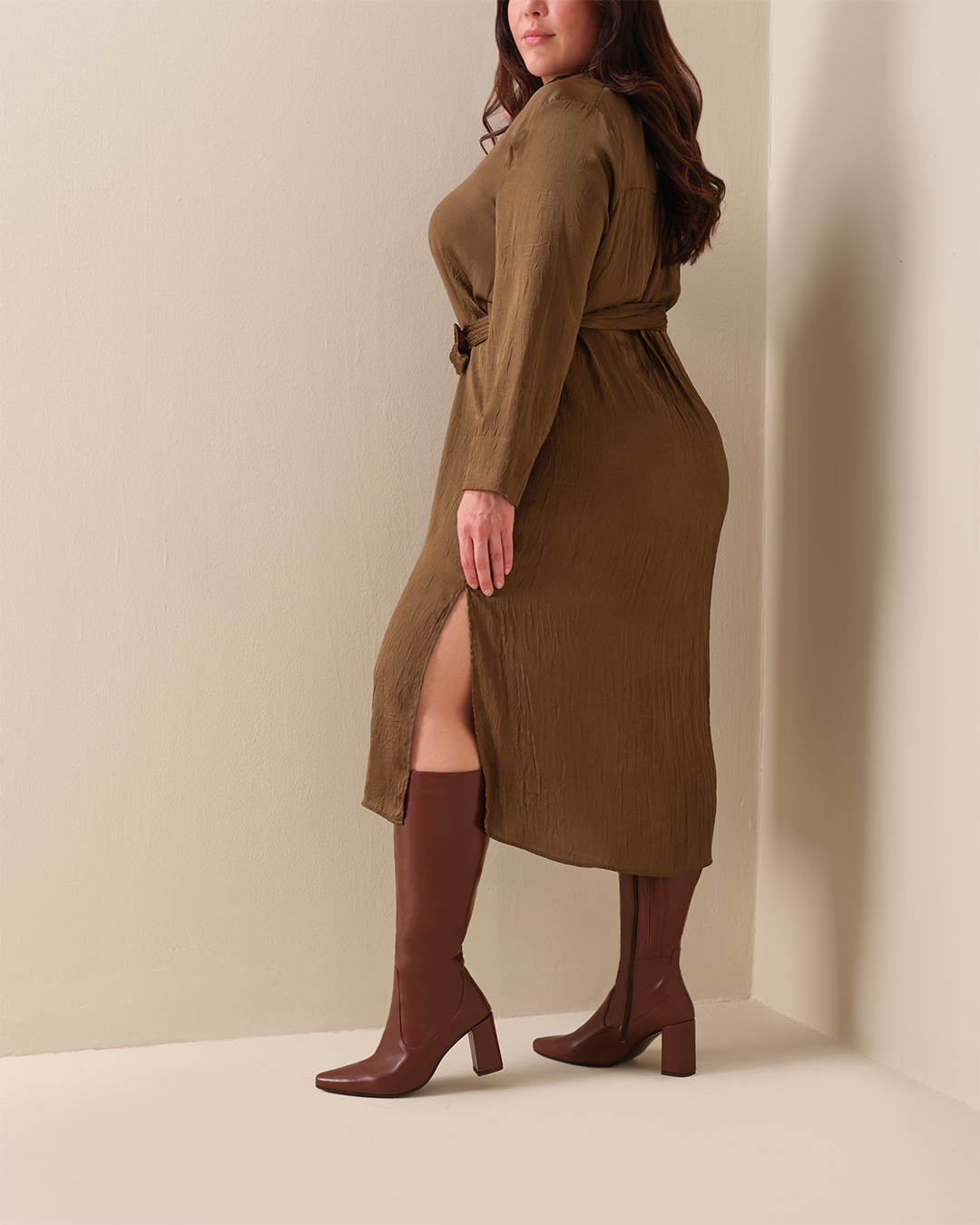 woman wearing knee high brown leather heeled boots