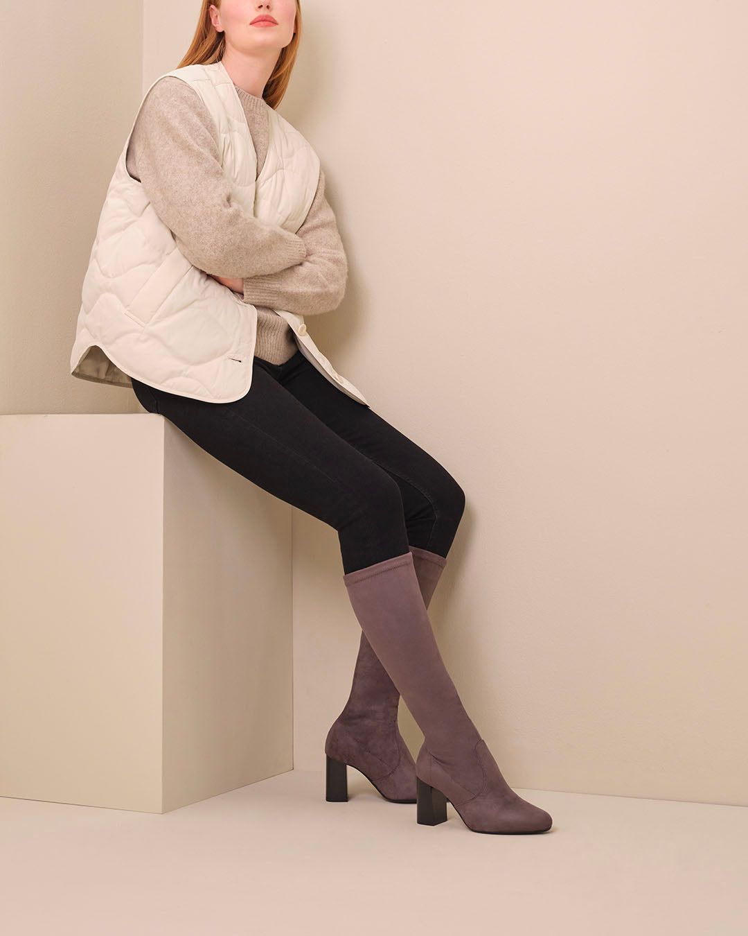 woman wearing knee high grey suede heeled boots
