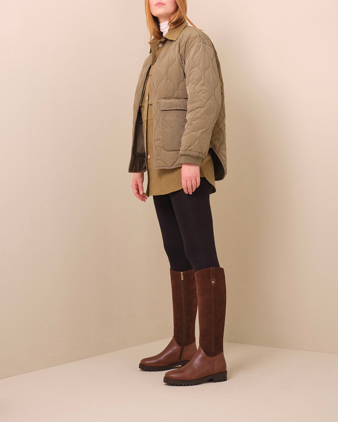 woman in knee high brown boots